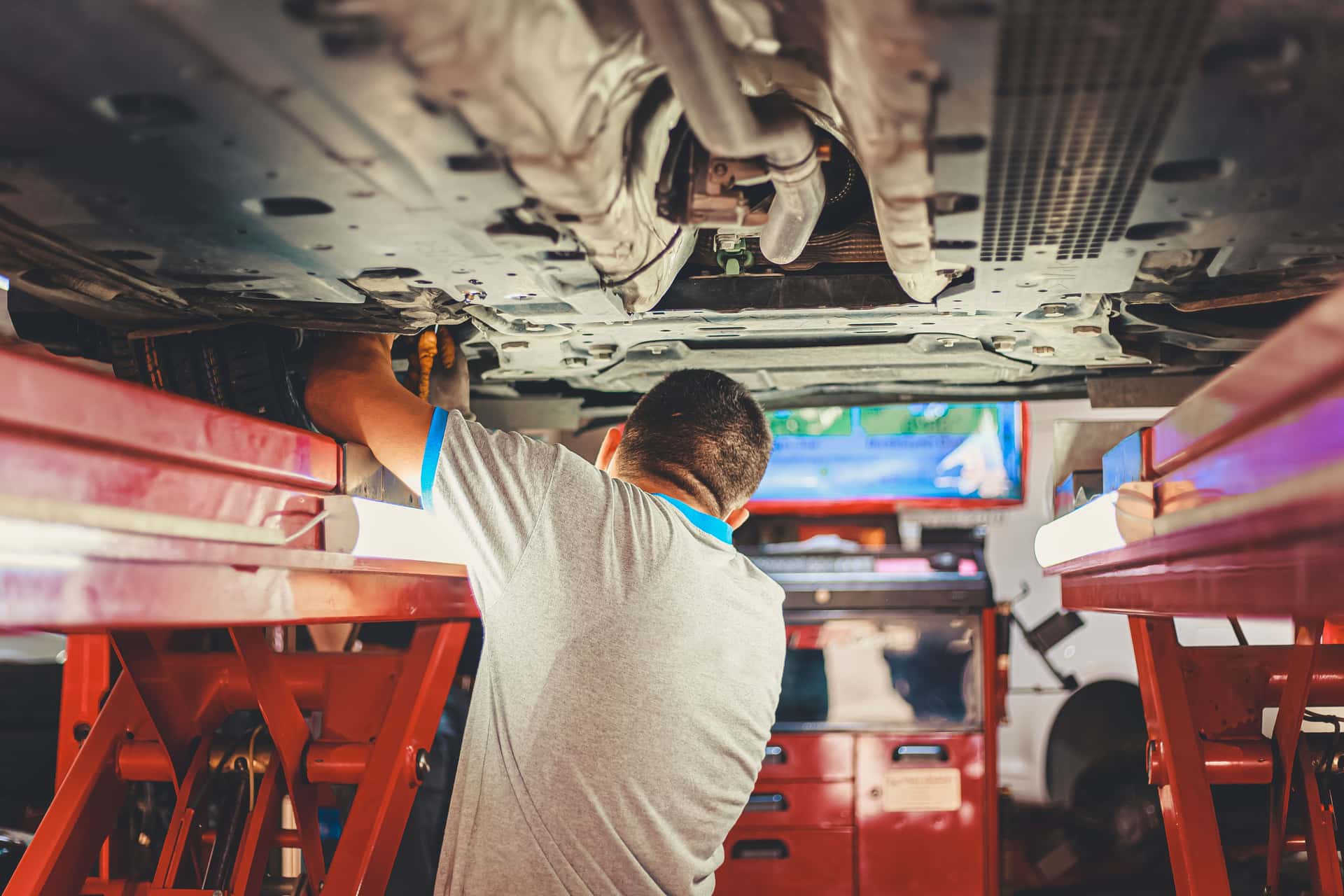 A service technician working with both hands, unable to answer a ringing phone
