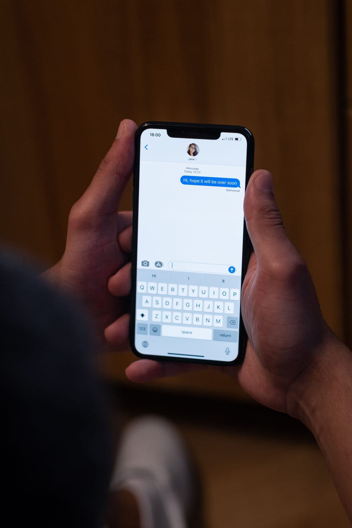 A phone showing a text-message conversation booking a service appointment